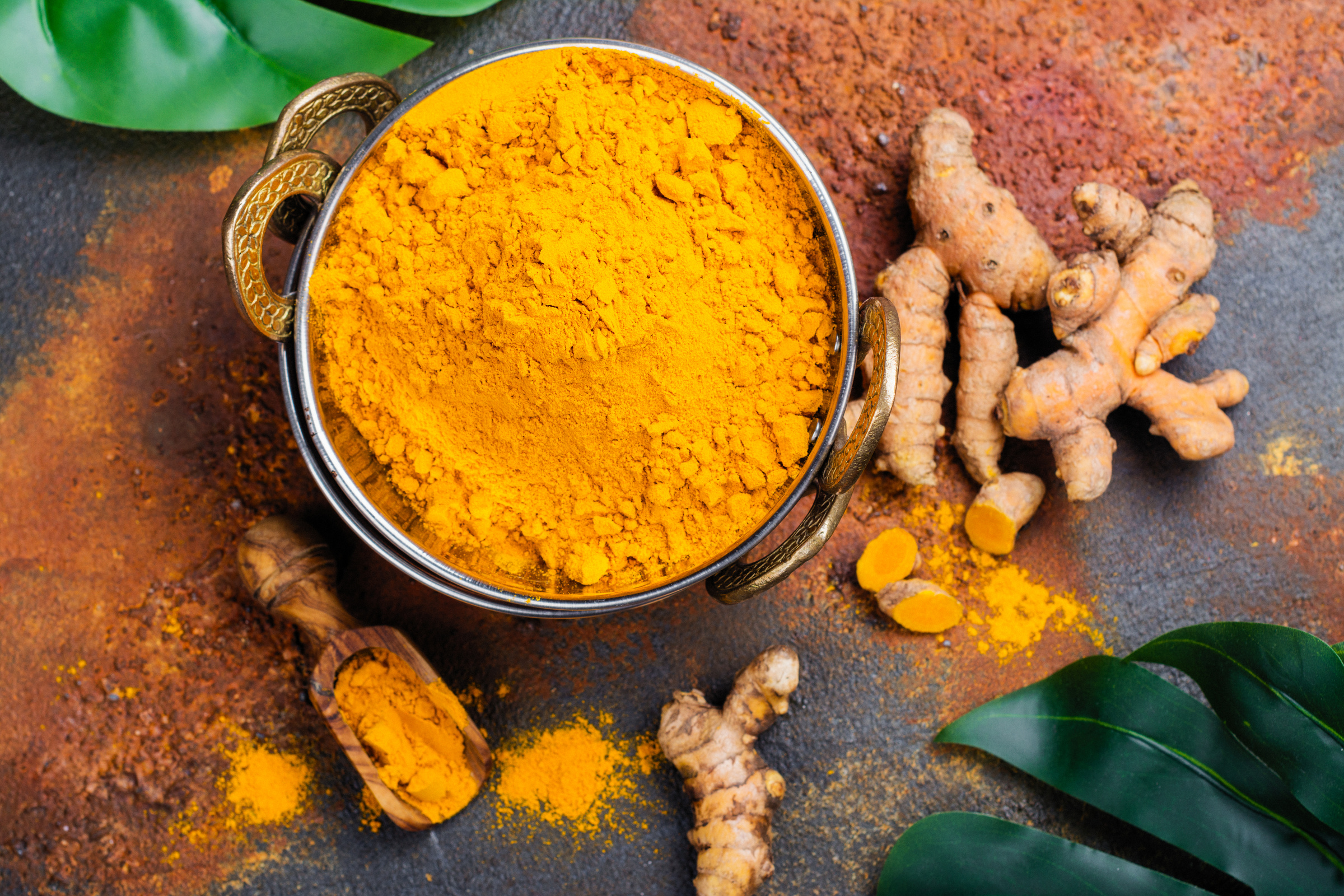 Turmeric Powder and Fresh Root on Grunge Background